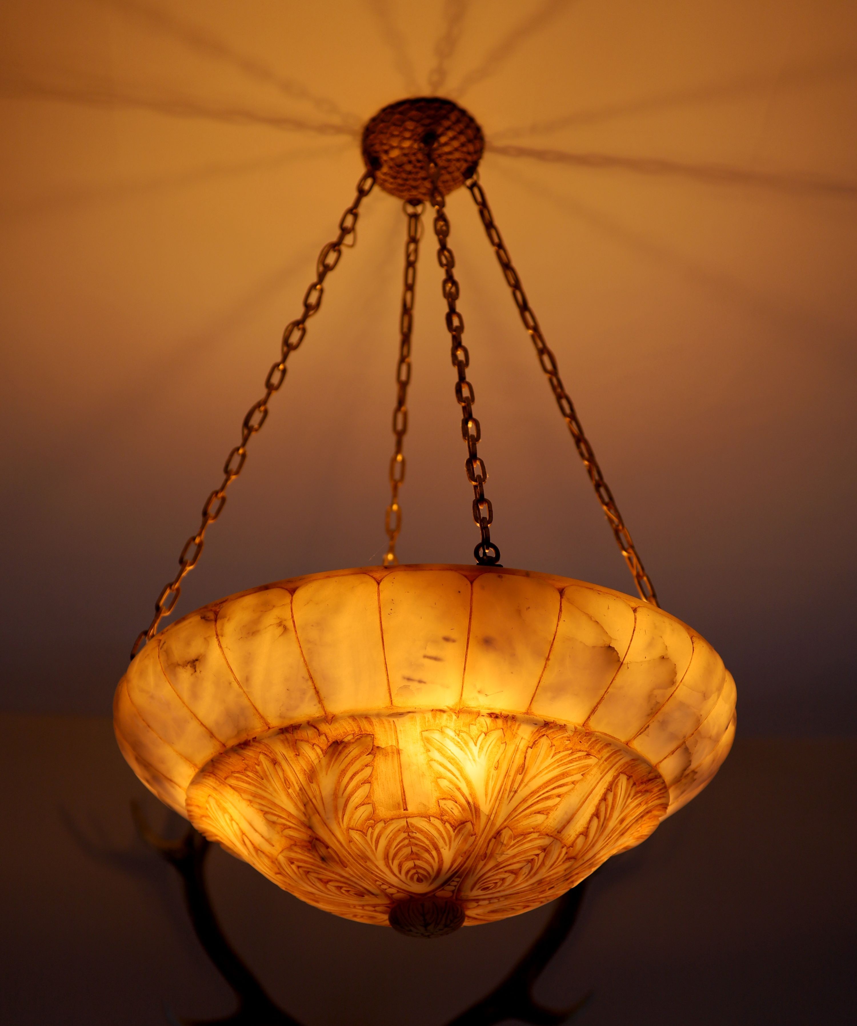 A foliate carved alabaster light bowl, diameter 56cm drop including chains 90cm
